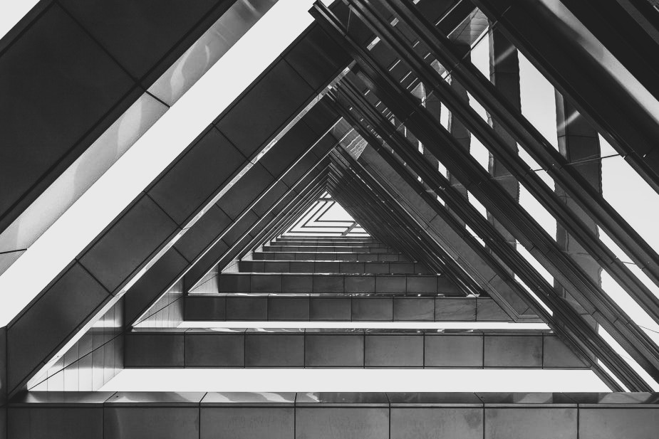 triangle-shaped-architecture how to build a site architecture - photo of a black and white building structured and stacked on top of each other